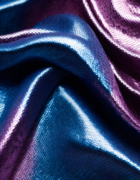 Shimmering blue and purple textured fabric draped elegantly on a surface