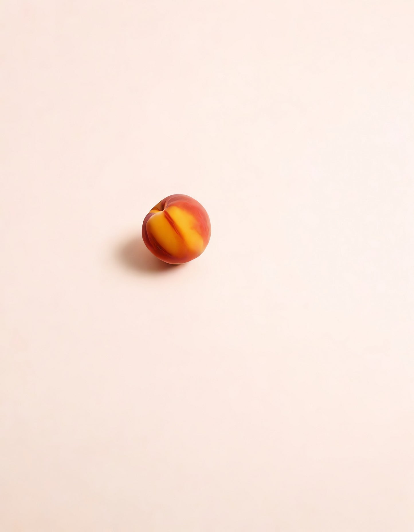 Single ripe peach sits on a light background, highlighting its smooth skin texture and vibrant colors in natural light