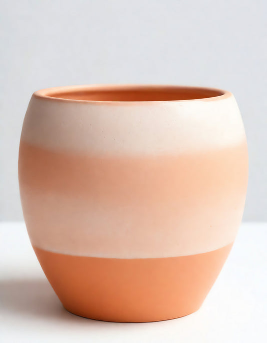 Simple ceramic planter with a smooth gradient from warm peach to soft cream, perfect for indoor or outdoor decor