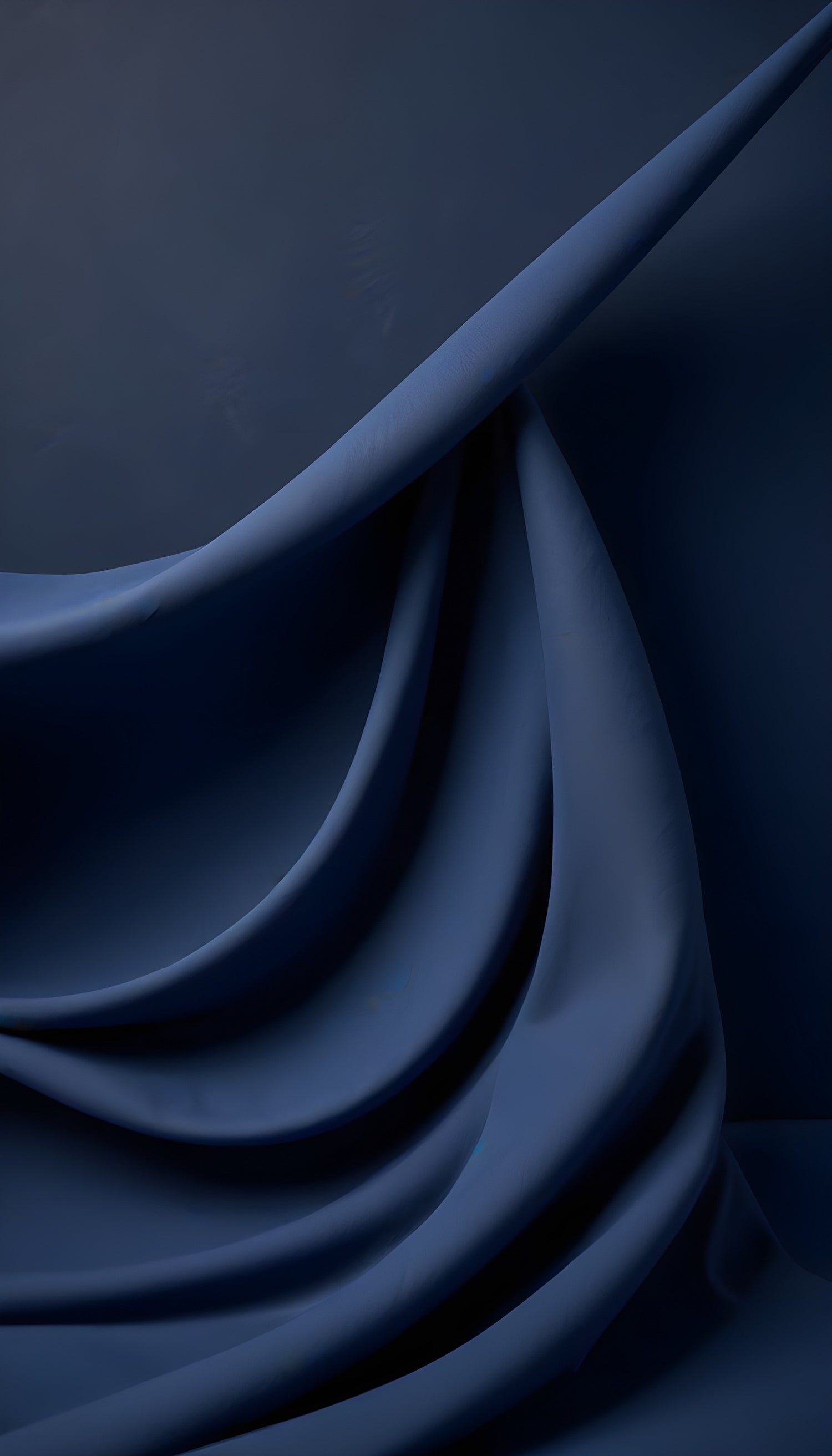 Dark blue fabric draped elegantly in varying folds, showcasing texture and depth in a soft, ambient light setting