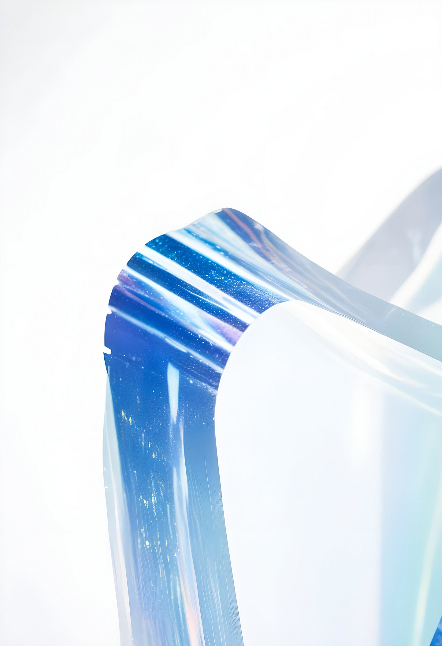 Abstract close-up of translucent blue acrylic sheet displaying light reflections in a minimalist indoor space