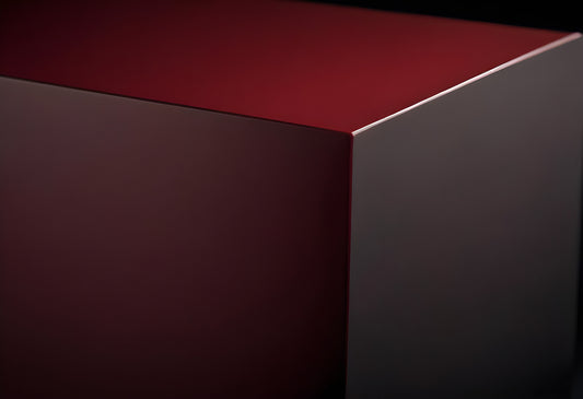 Abstract geometric shape with rich maroon color and smooth surfaces, captured in well-defined lighting and shadow contrast