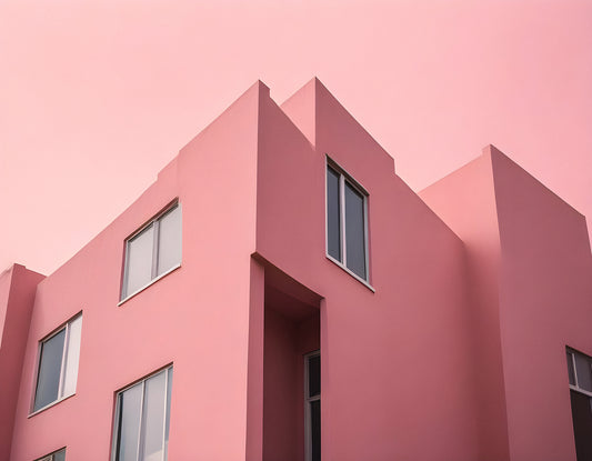 Modern pink building with angular design captured against a pastel sky in early evening light