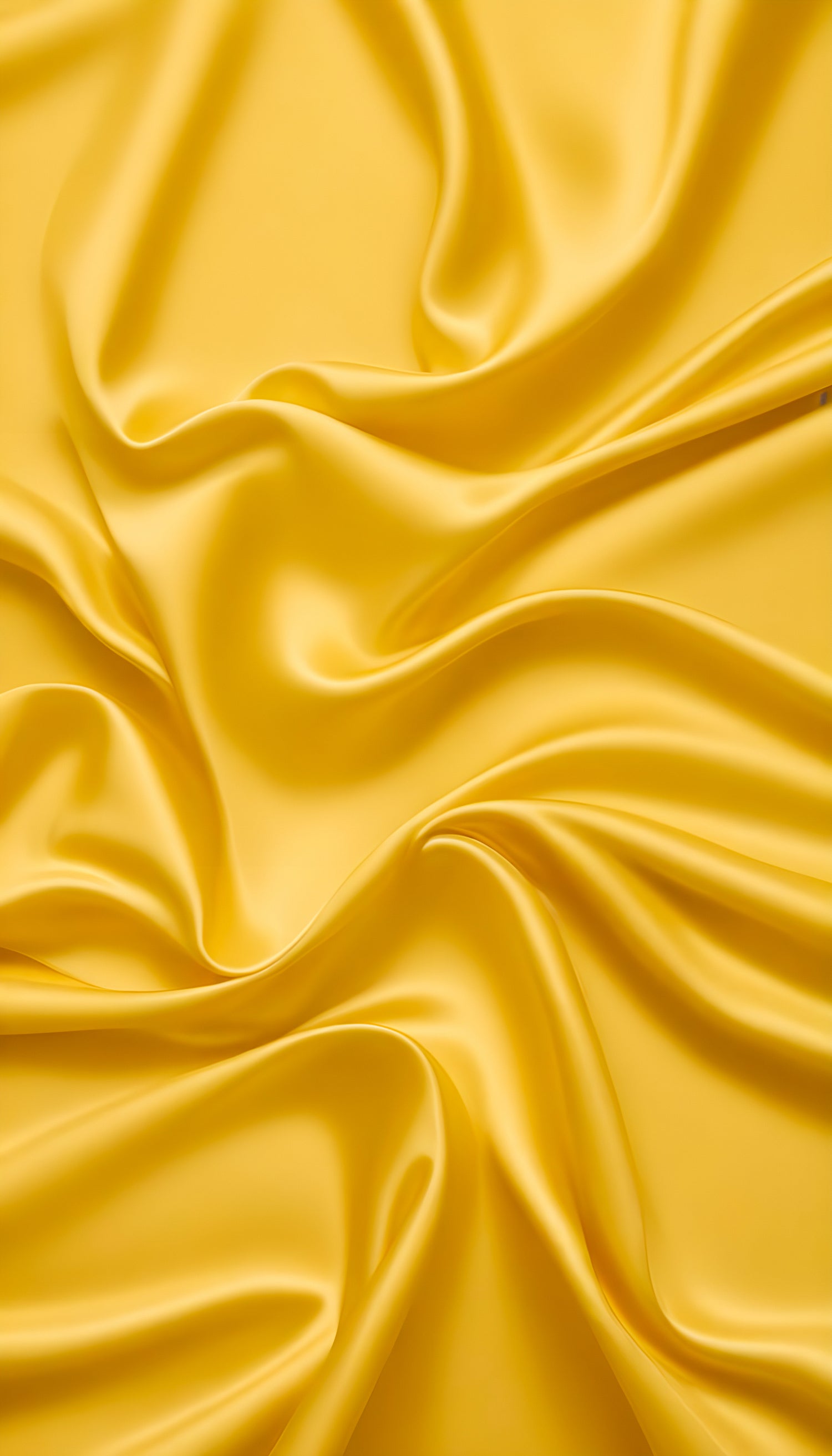 Soft yellow satin fabric draped elegantly on a surface, showcasing its smooth texture and vibrant color under natural light