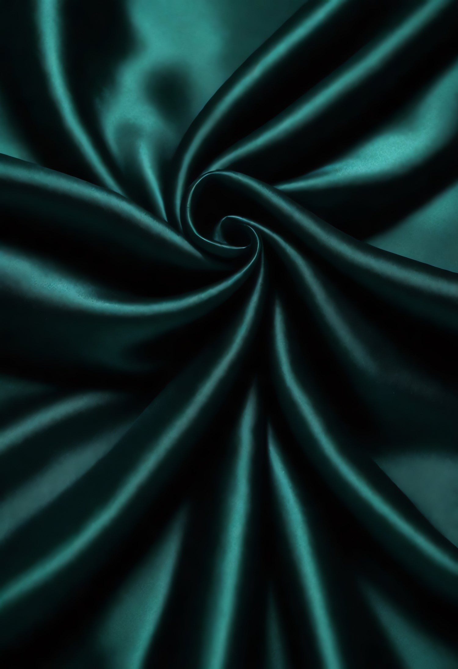 Elegant teal silk fabric swirling in a spiral pattern, showcasing its smooth texture and rich color under soft lighting