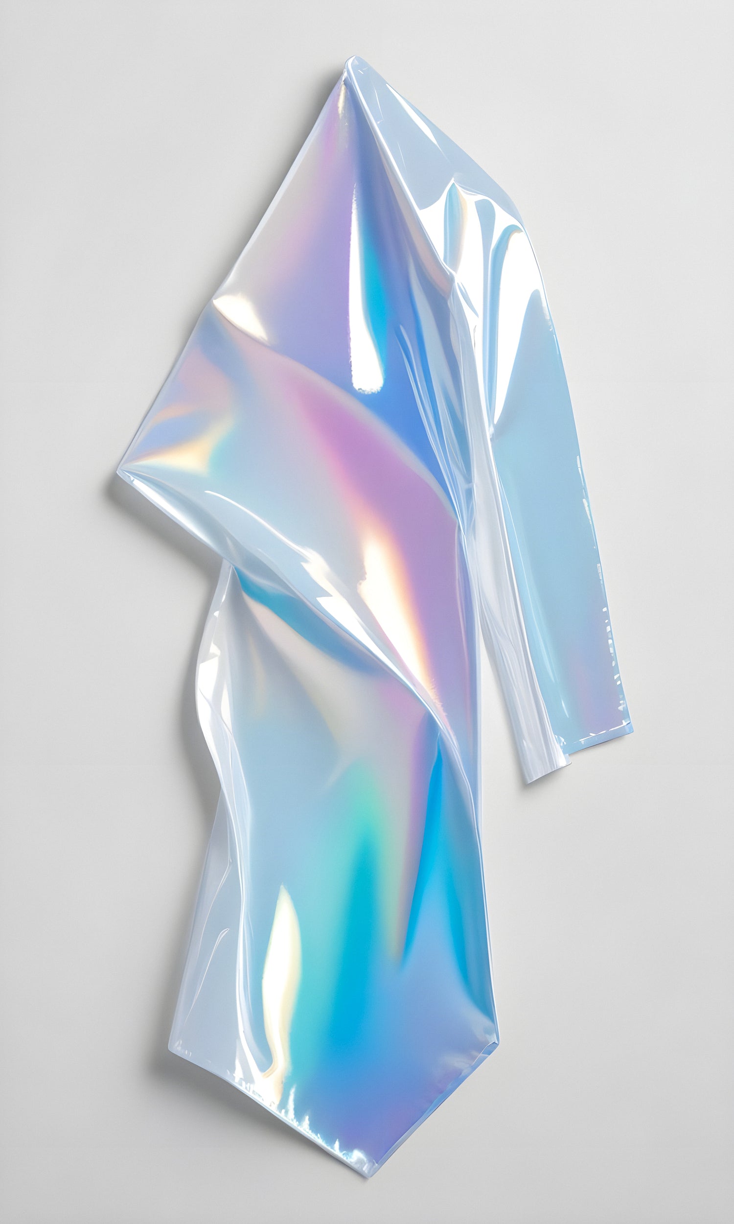 Holographic reflective film draped artistically on a light gray background showcasing vivid colors and smooth texture