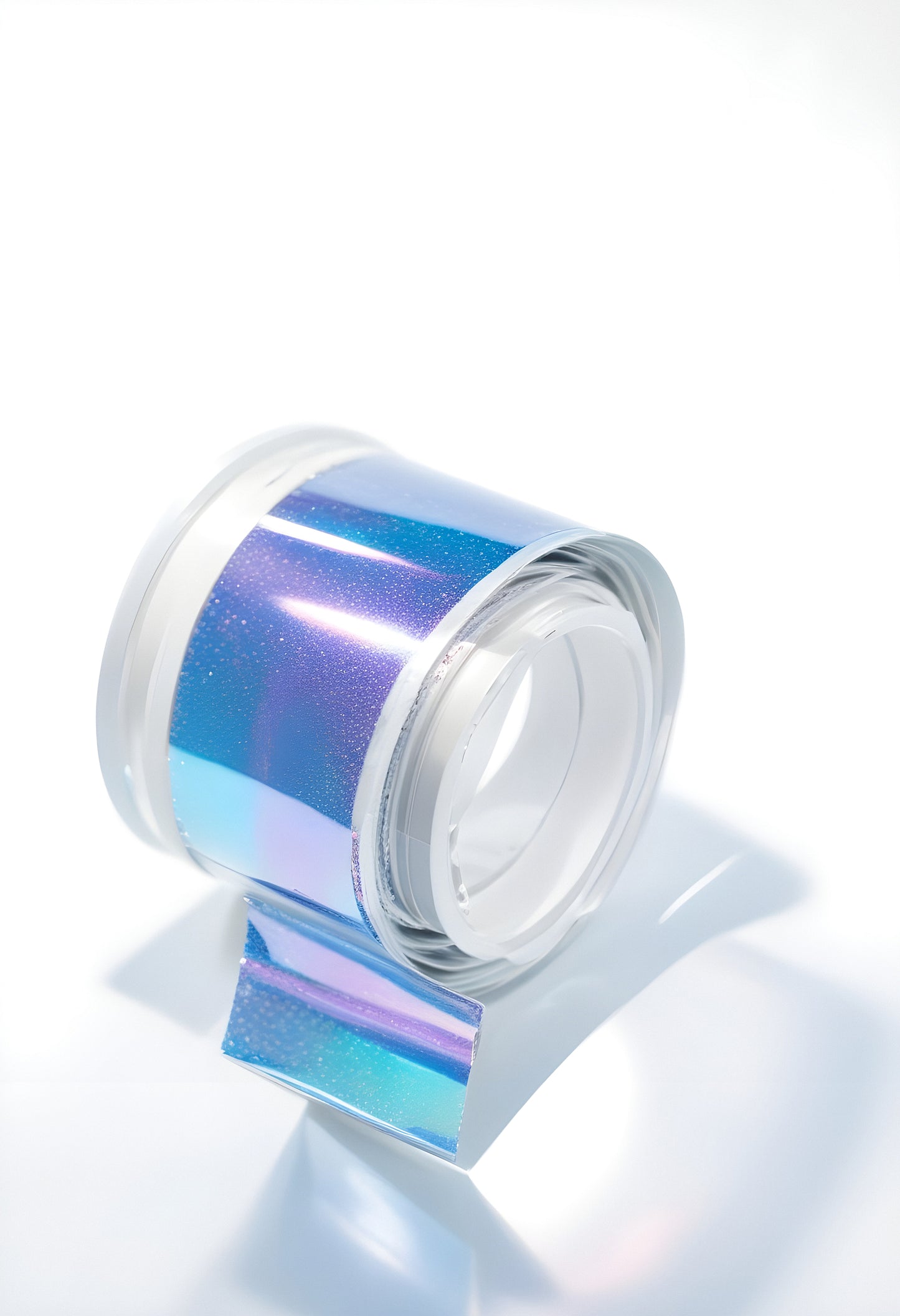 Shiny holographic tape roll displayed on a white surface, showcasing vibrant colors and reflective quality in natural light