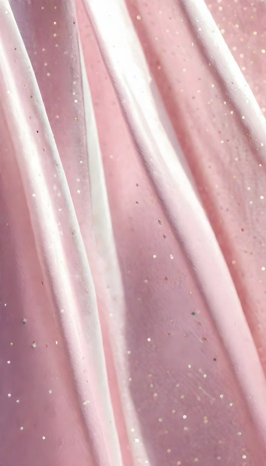 A close-up view of soft, shiny pink fabric draped elegantly, highlighting its smooth texture and sheen, perfect for luxurious designs