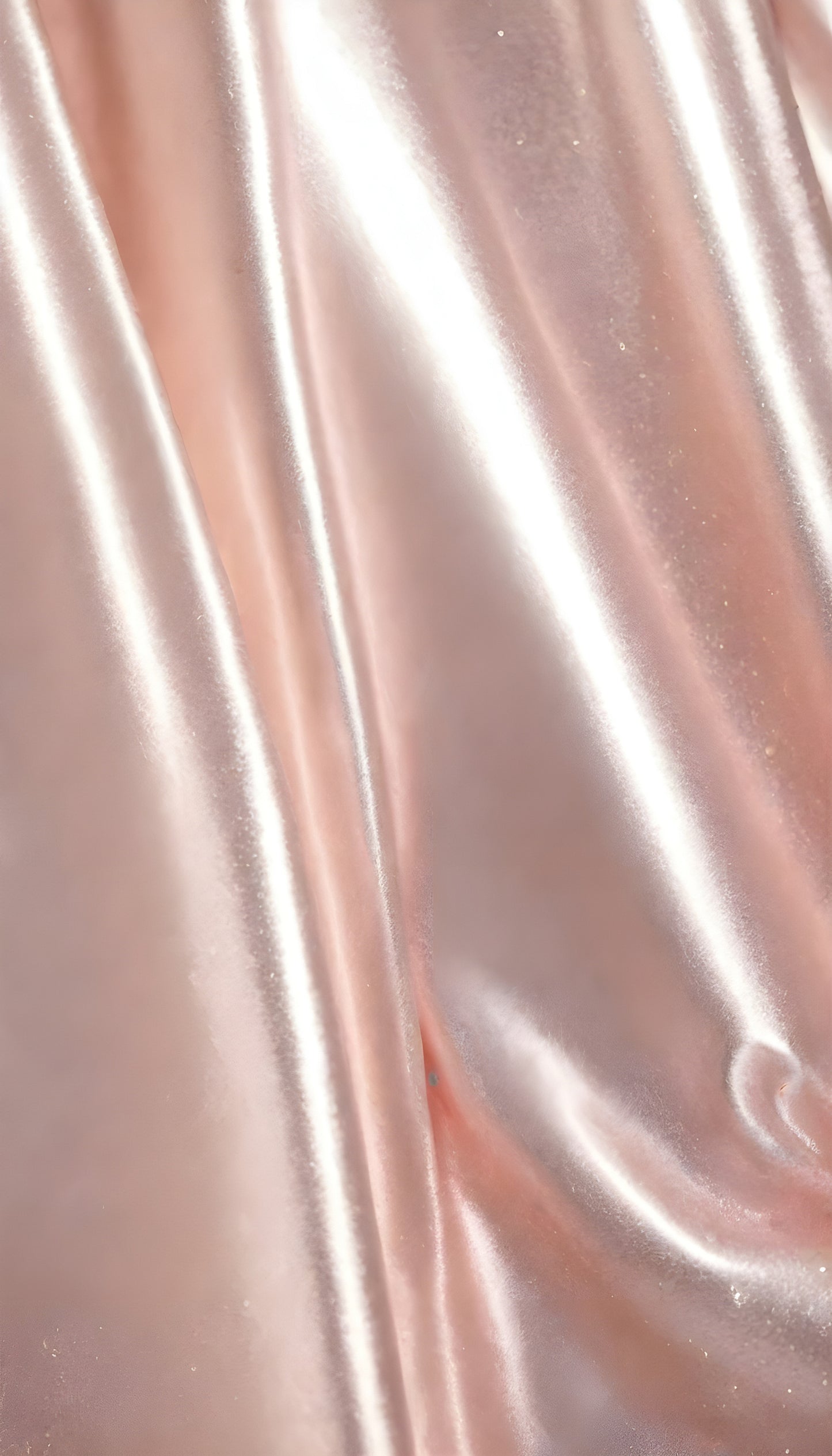 Silky pink fabric draped elegantly, highlighting smooth texture and sheen in natural light during a serene afternoon