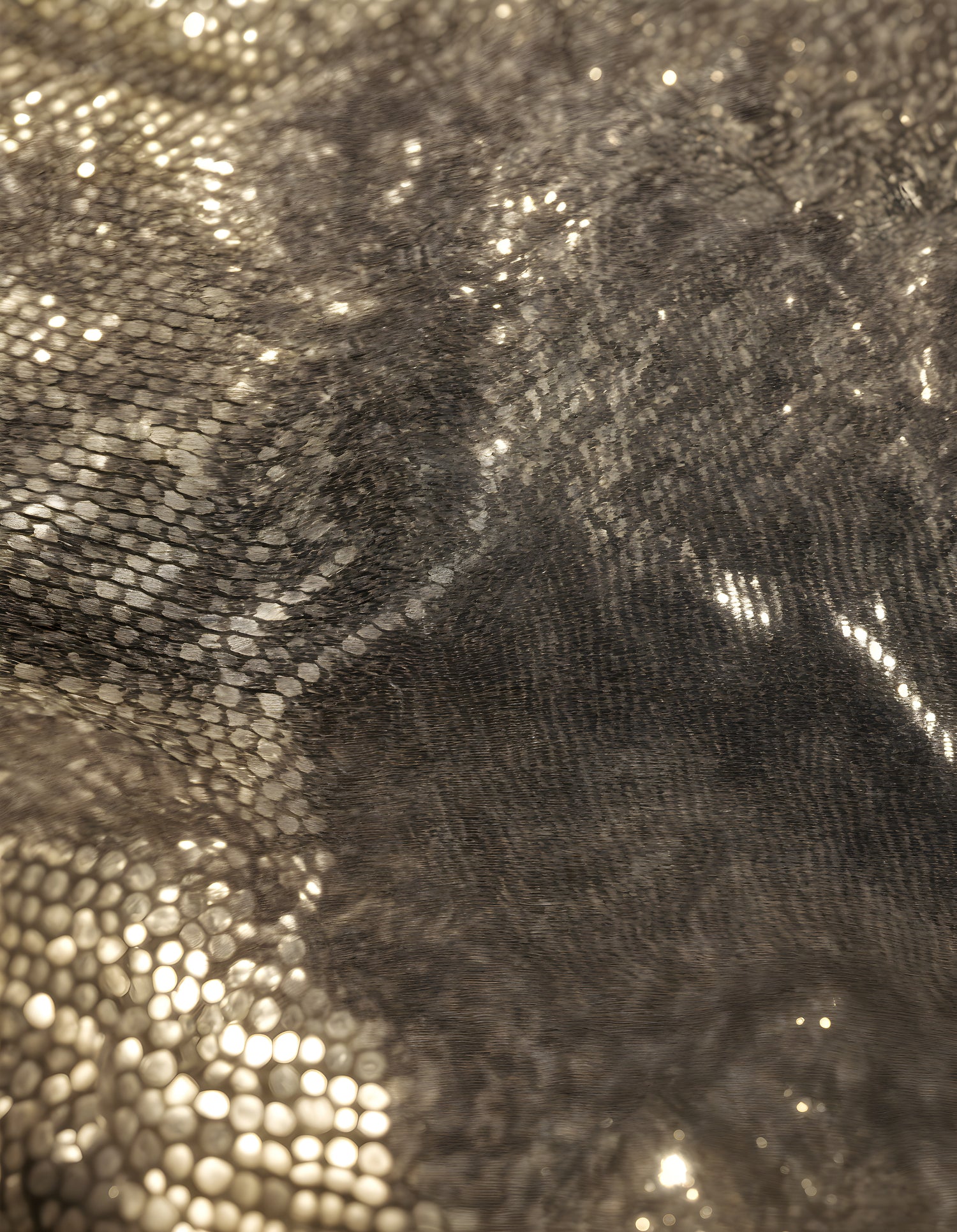 Sparkling golden fabric draping gracefully under soft light during a creative textile project