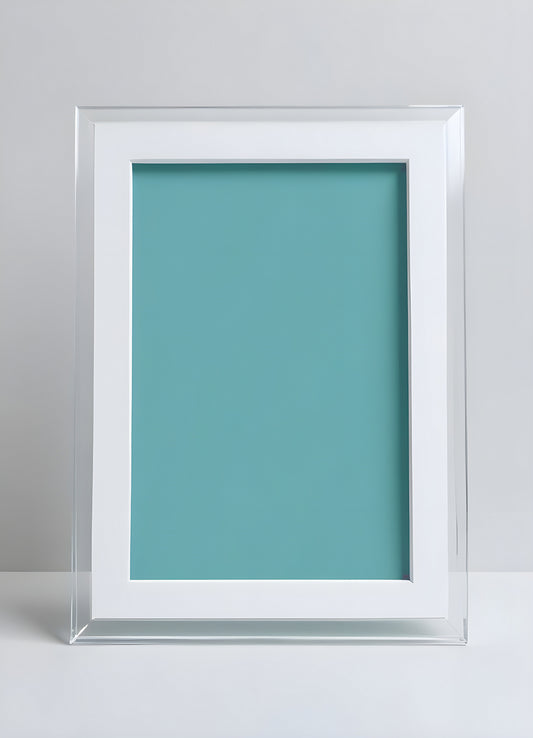 Simple clear frame with aqua background positioned on white surface in a minimalist interior setting