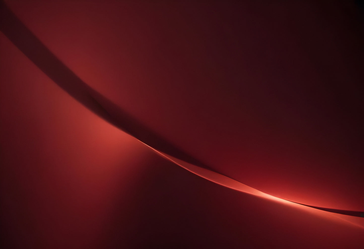 A soft glowing curve against a deep red background creates an abstract and calming visual experience in a minimalist setting