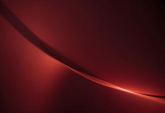 A soft glowing curve against a deep red background creates an abstract and calming visual experience in a minimalist setting