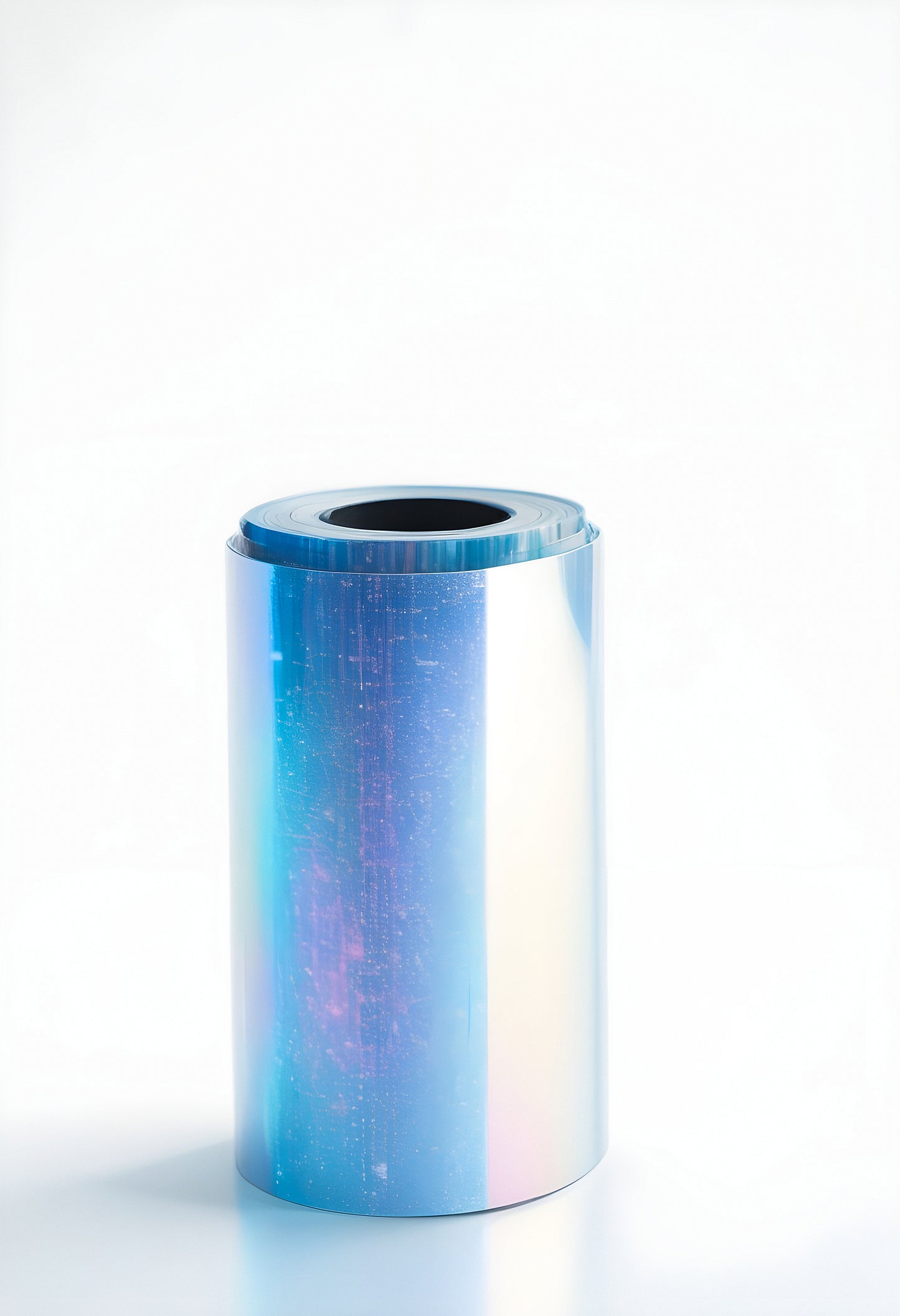 Shiny metallic roll with iridescent surface reflecting light on a plain background