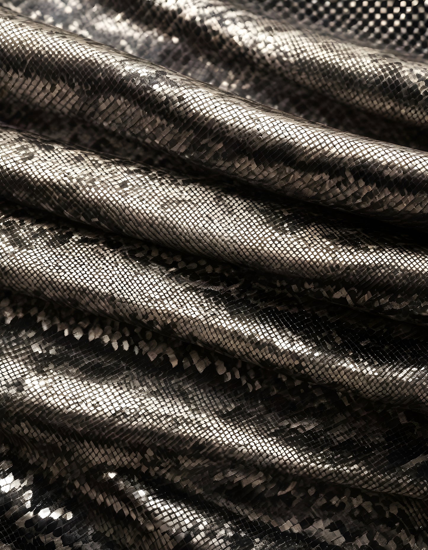 Elegant metallic fabric with a textured snake skin pattern draped softly