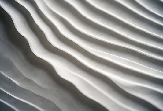 Abstract texture of smooth, flowing lines in soft gray hues highlighted by gentle light