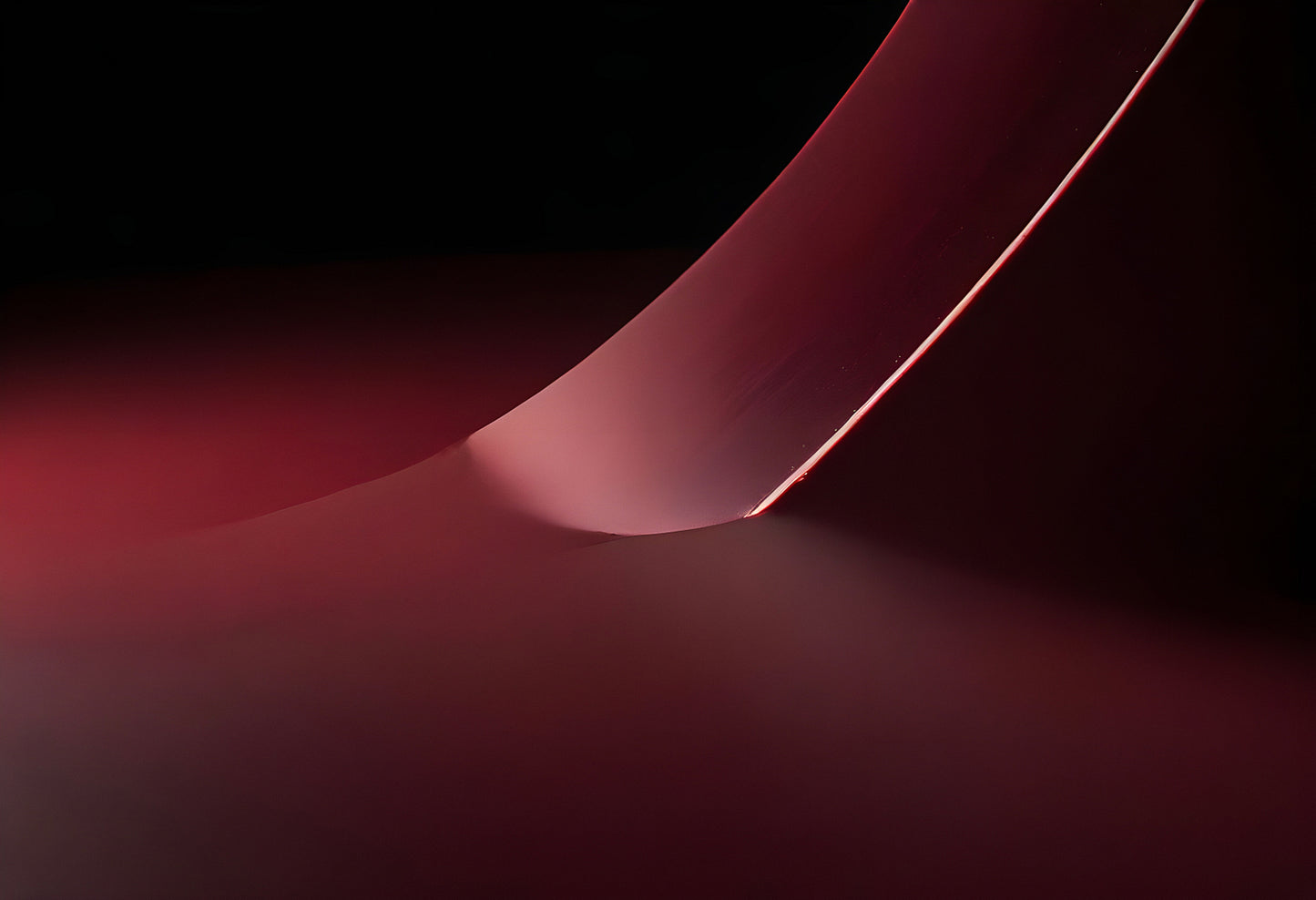 Abstract light playing on a curved surface in a darkened environment showcasing artistic design and color interplay at dusk