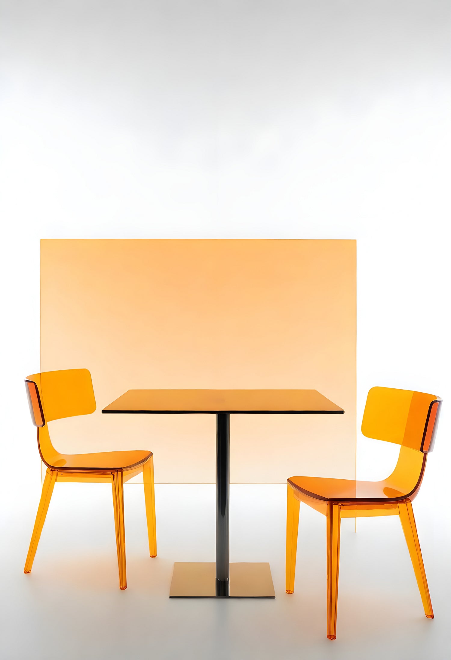 Minimalist dining setup with transparent orange chairs and a square table against a soft backdrop