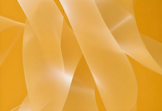 Abstract yellow ribbons flowing elegantly in soft light create a dynamic and vibrant atmosphere in an artistic composition