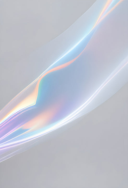 Translucent, iridescent fabric flowing gracefully against a soft gray backdrop in natural light