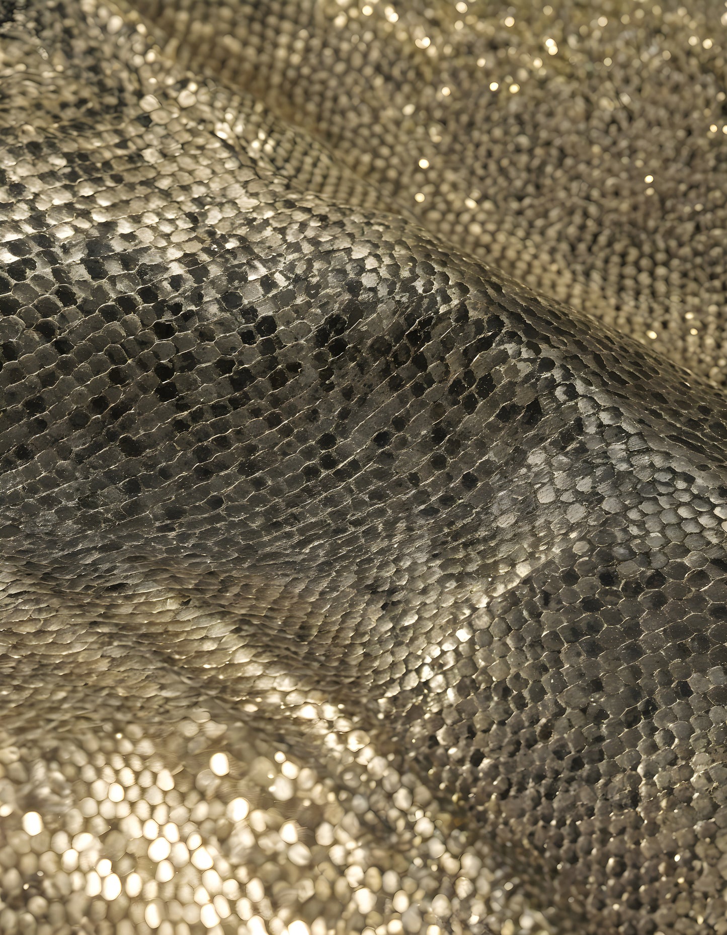 Sparkling golden fabric draping gracefully under soft light during a creative textile project