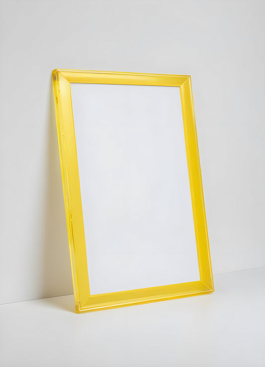 A bright yellow frame leaning against a simple white wall with a smooth surface and a minimalistic background