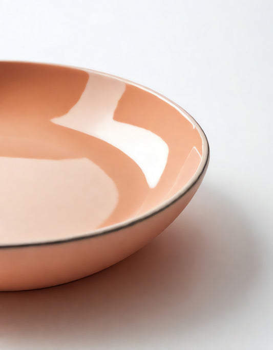 Ceramic dish in soft peach color displayed on a light background for minimalist kitchen decor ideas