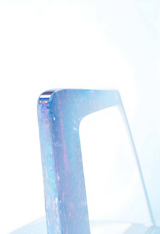 A close-up view of an elegant transparent object reflecting light against a soft white background, showcasing its unique design and structure