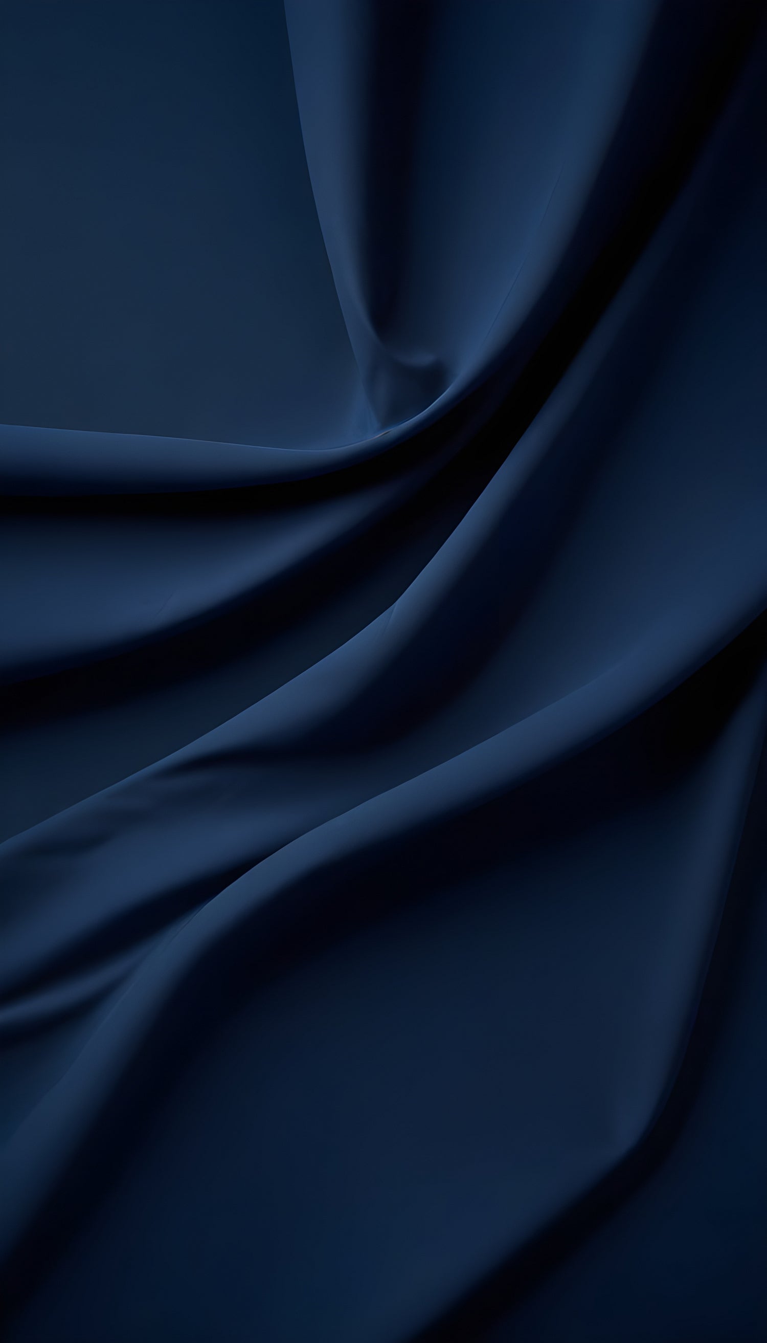 Soft navy fabric draped gracefully, capturing light and shadow in an elegant arrangement for textiles or fashion design