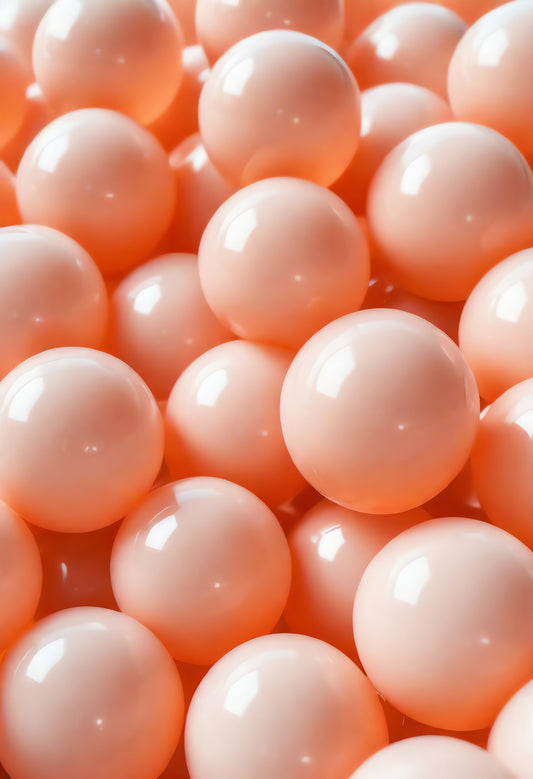 Close-up view of numerous smooth peach-colored balls arranged closely together in a playful setting, ideal for games or decoration