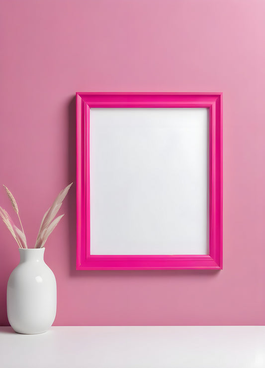 Bright pink empty frame stands against a white wall, inviting creativity and personal expression