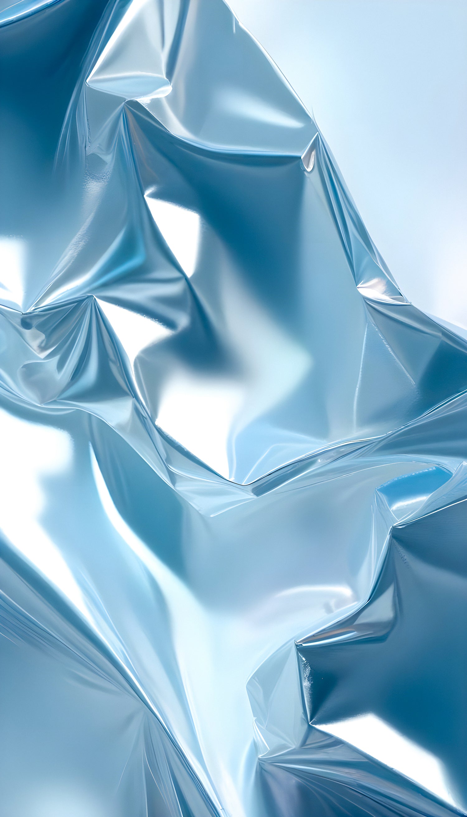 Shimmering blue crumpled metallic foil creating an abstract texture under soft lighting in a studio setting